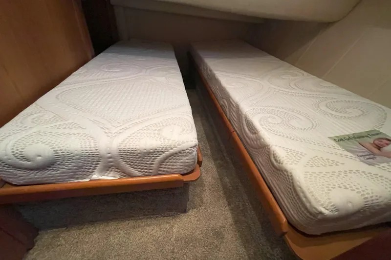  Yacht Photos Pics Twin beds in a 2000 Mainship 390 Trawler cabin with patterned mattresses.