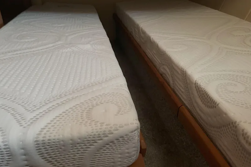  Yacht Photos Pics Twin beds with patterned mattresses on a 2000 Mainship 390 Trawler.
