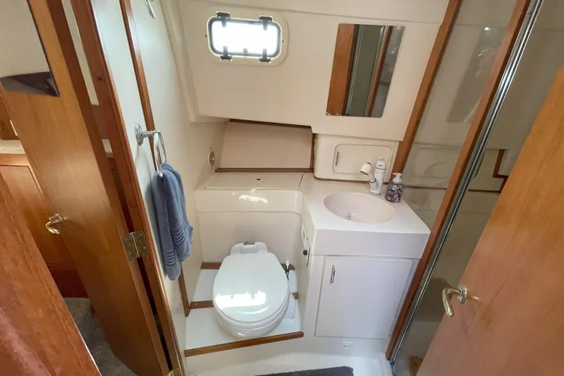  Yacht Photos Pics Bathroom interior of 2000 Mainship 390 Trawler with toilet, sink, and shower.