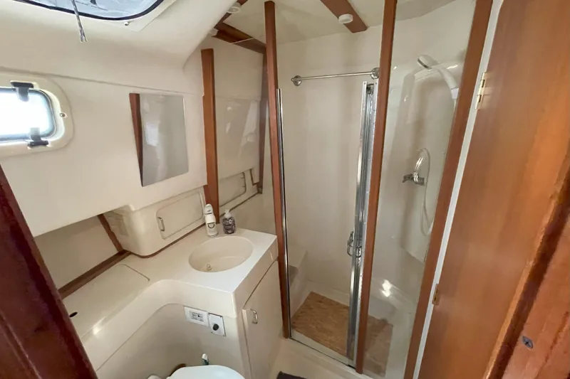  Yacht Photos Pics Bathroom interior of 2000 Mainship 390 Trawler with shower and sink.
