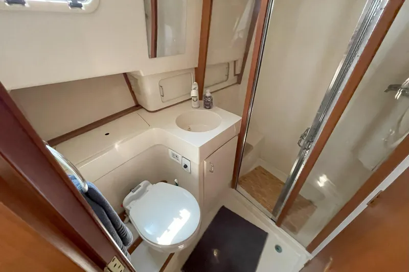  Yacht Photos Pics Bathroom interior of 2000 Mainship 390 Trawler with shower, sink, and toilet.