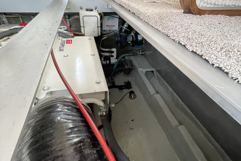  Yacht Photos Pics Engine compartment of a 2000 Mainship 390 Trawler, showcasing mechanical components and wiring.