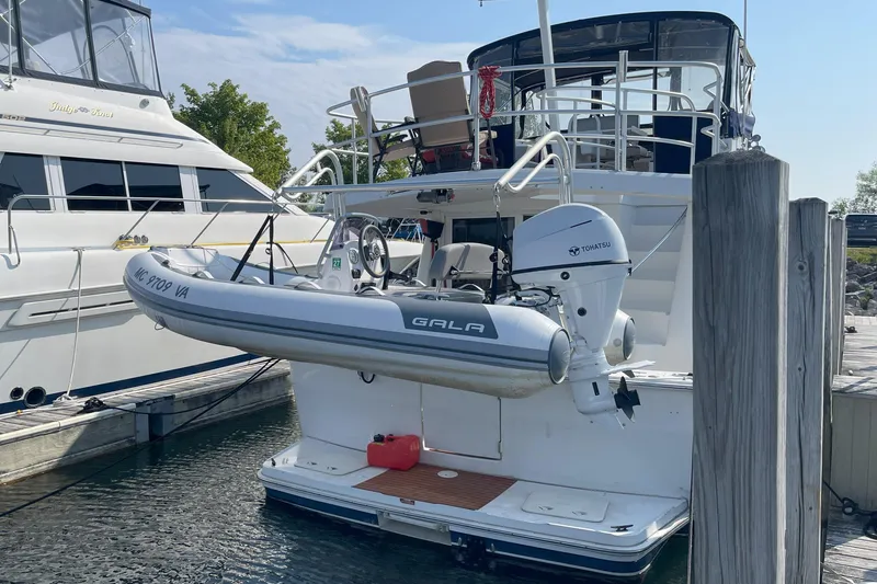  Yacht Photos Pics 2000 Mainship 390 Trawler docked with attached inflatable boat and Tohatsu motor.