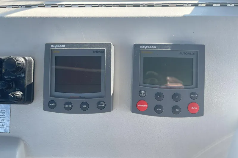  Yacht Photos Pics Raytheon Tridata and Autopilot displays on 2000 Mainship 390 Trawler dashboard.