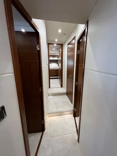  Yacht Photos Pics Interior hallway of 2016 Sunseeker 75 Yacht with wooden doors and modern lighting.