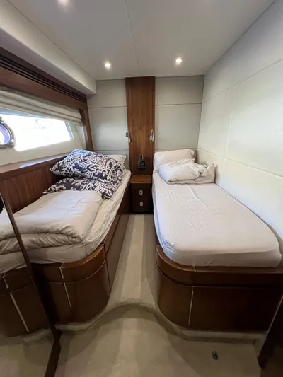  Yacht Photos Pics Interior cabin of 2016 Sunseeker 75 Yacht with twin beds and wooden accents.