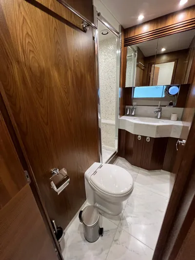  Yacht Photos Pics Luxurious bathroom in 2016 Sunseeker 75 Yacht with wood accents and modern fixtures.