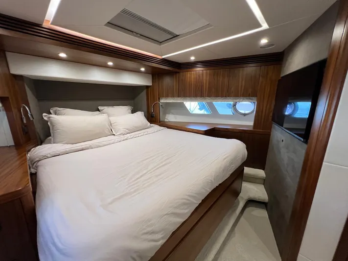  Yacht Photos Pics Luxurious bedroom interior of a 2016 Sunseeker 75 Yacht with elegant wood paneling.