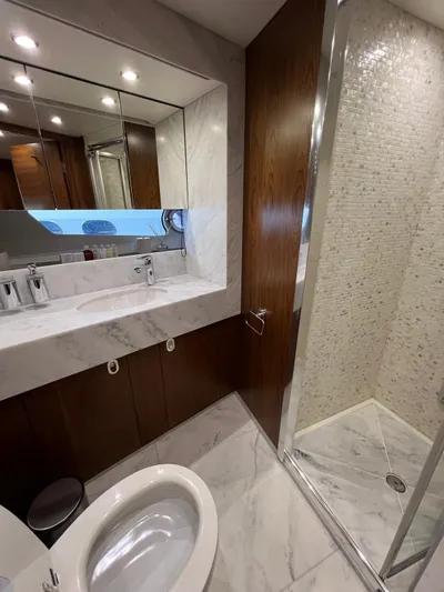  Yacht Photos Pics Luxurious bathroom in a 2016 Sunseeker 75 Yacht with marble and wood finishes.