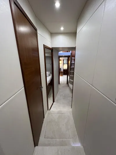  Yacht Photos Pics Interior hallway of 2016 Sunseeker 75 Yacht, featuring sleek design and modern lighting.