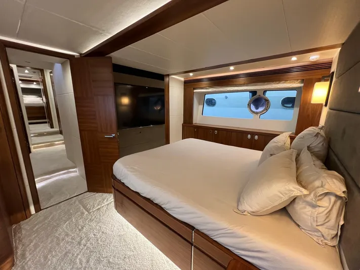  Yacht Photos Pics Luxurious bedroom interior of 2016 Sunseeker 75 Yacht with elegant wood finishes.
