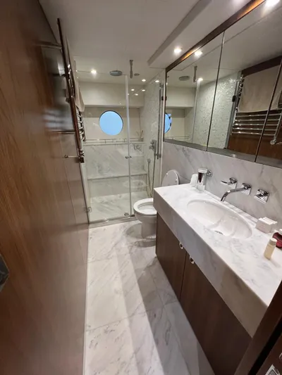  Yacht Photos Pics Luxurious bathroom in a 2016 Sunseeker 75 Yacht with marble finishes and modern fixtures.