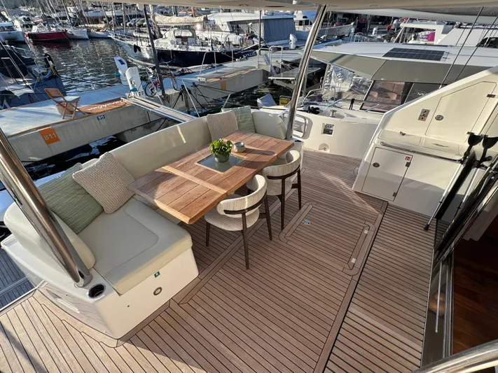  Yacht Photos Pics Sunseeker 75 Yacht 2016 deck with seating area and table, docked at marina.
