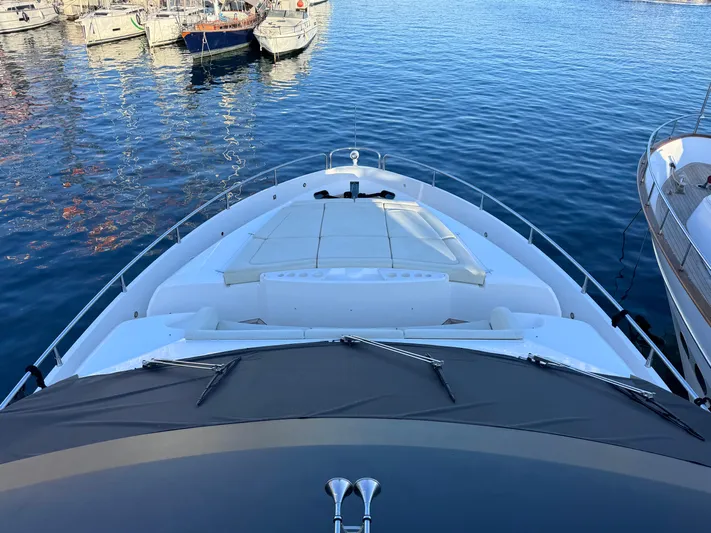  Yacht Photos Pics 2016 Sunseeker 75 Yacht bow view, docked in a marina with calm water.