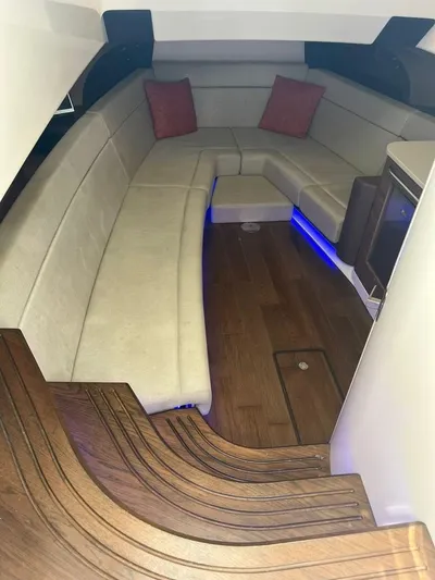 Bite Me Yacht Photos Pics 2017 Boston Whaler 420 Outrage cabin with seating, wood flooring, and ambient lighting.