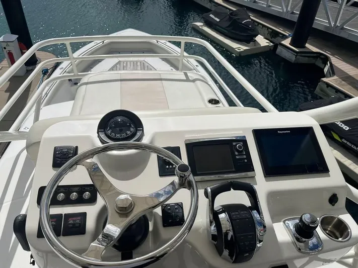 Bite Me Yacht Photos Pics Boston Whaler 420 Outrage 2017 helm with steering wheel and navigation controls.