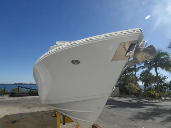  Yacht Photos Pics 2020 Cobia 320 Center Console boat on land, clear sky background.