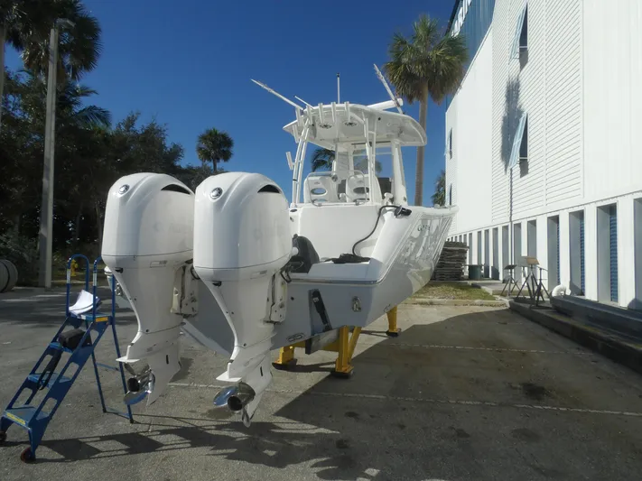  Yacht Photos Pics 2020 Cobia 320 Center Console boat with dual outboard engines on a sunny day.