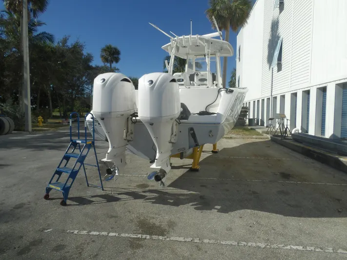 Yacht Photos Pics 2020 Cobia 320 Center Console boat with dual outboard engines on a trailer.