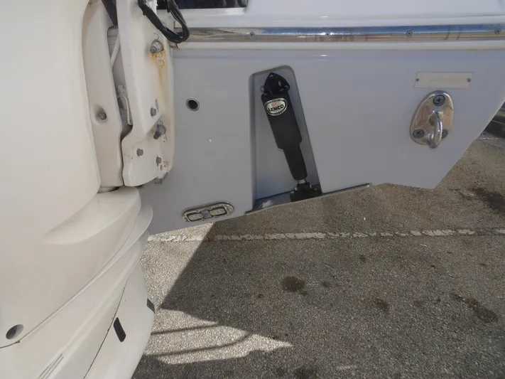  Yacht Photos Pics 2020 Cobia 320 Center Console boat detail showing engine mount and trim tab.