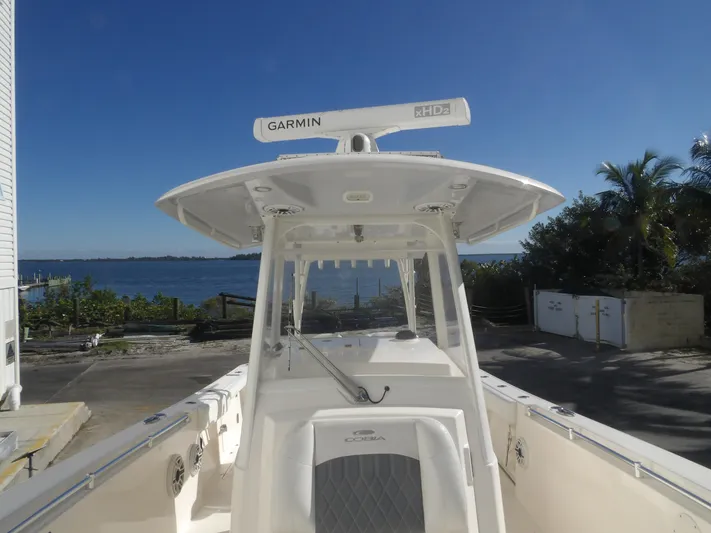  Yacht Photos Pics 2020 Cobia 320 Center Console boat docked near waterfront, featuring Garmin xHD2 radar.