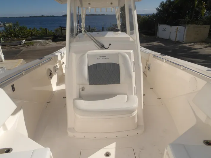  Yacht Photos Pics 2020 Cobia 320 Center Console boat interior with seating, near waterfront.