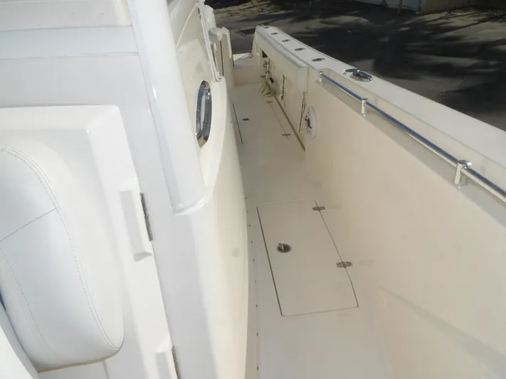  Yacht Photos Pics 2020 Cobia 320 Center Console boat deck with storage hatch and railing.