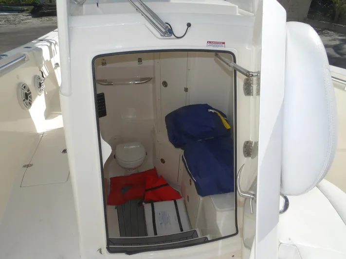  Yacht Photos Pics 2020 Cobia 320 Center Console boat interior with toilet and storage area.