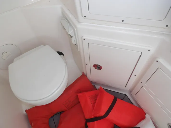  Yacht Photos Pics Interior of 2020 Cobia 320 Center Console with life jackets and marine toilet.