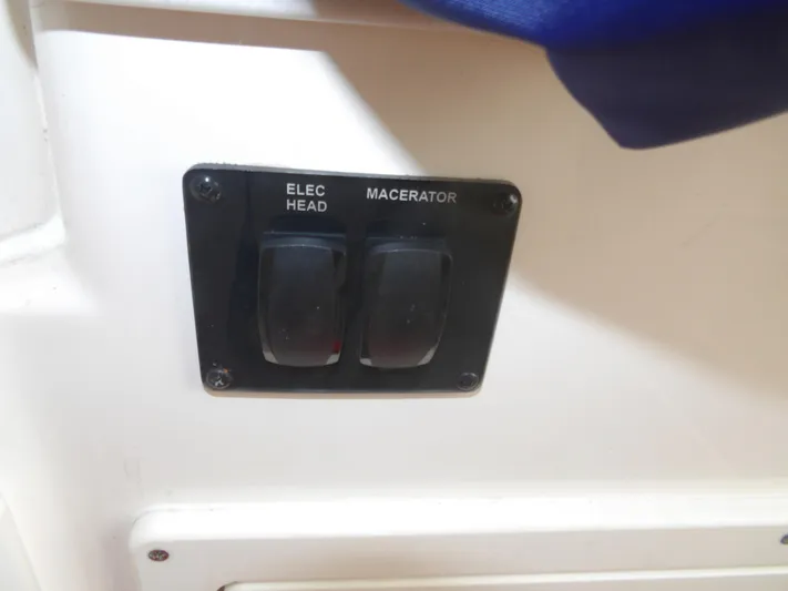  Yacht Photos Pics Switch panel on 2020 Cobia 320 Center Console boat, featuring electric head and macerator controls.