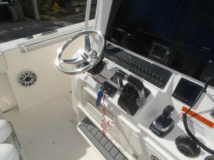  Yacht Photos Pics 2020 Cobia 320 Center Console boat dashboard with steering wheel and controls.