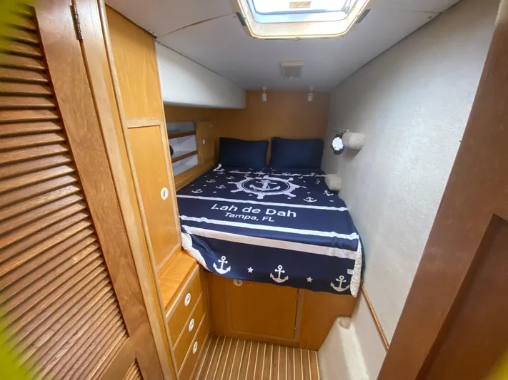 Lah De Dah Yacht Photos Pics Cozy cabin interior of 2007 Manta 44 Power Cat with nautical-themed bedding.