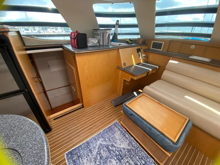 Lah De Dah Yacht Photos Pics Interior of 2007 Manta 44 Power Cat with modern seating and wooden finishes.