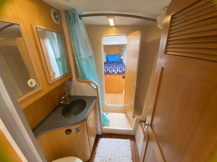 Lah De Dah Yacht Photos Pics 2007 Manta 44 Power Cat bathroom with sink, mirror, and view into cabin.