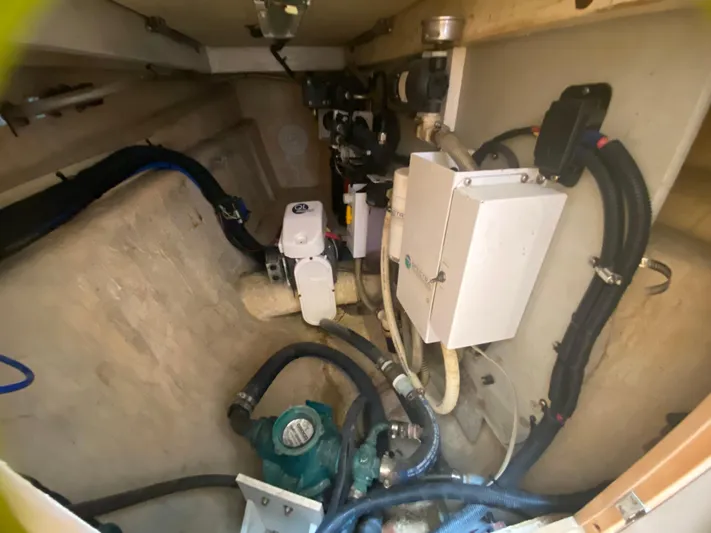 Lah De Dah Yacht Photos Pics Engine compartment of 2007 Manta 44 Power Cat with various mechanical components and hoses.