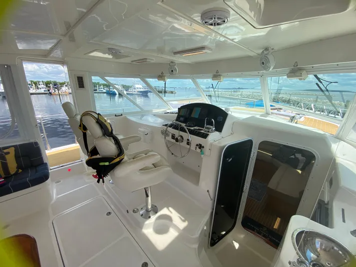 Lah De Dah Yacht Photos Pics Interior of 2007 Manta 44 Power Cat, featuring helm station and panoramic windows.