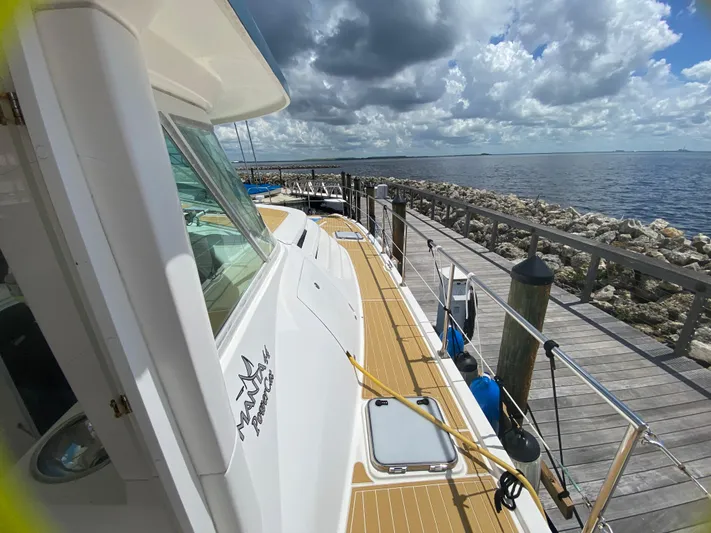 Lah De Dah Yacht Photos Pics 2007 Manta 44 Power Cat docked by the sea under a cloudy sky.