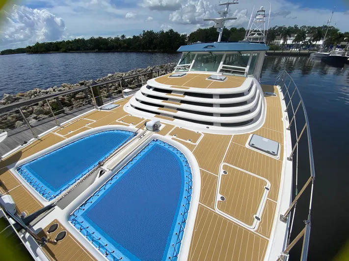 Lah De Dah Yacht Photos Pics 2007 Manta 44 Power Catamaran docked, featuring spacious deck and blue netting.