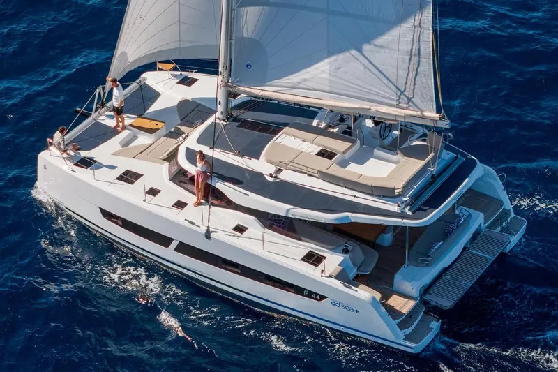  Yacht Photos Pics Manufacturer Provided Image: 2026 Fountaine Pajot FP44 Catamaran sailing on open blue sea with passengers onboard.
