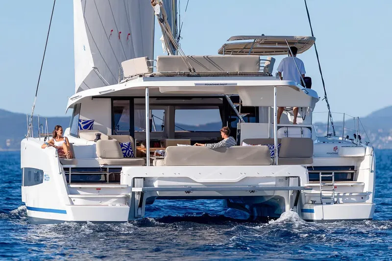  Yacht Photos Pics Manufacturer Provided Image: 2026 Fountaine Pajot FP44 Catamaran sailing with passengers on a sunny day.