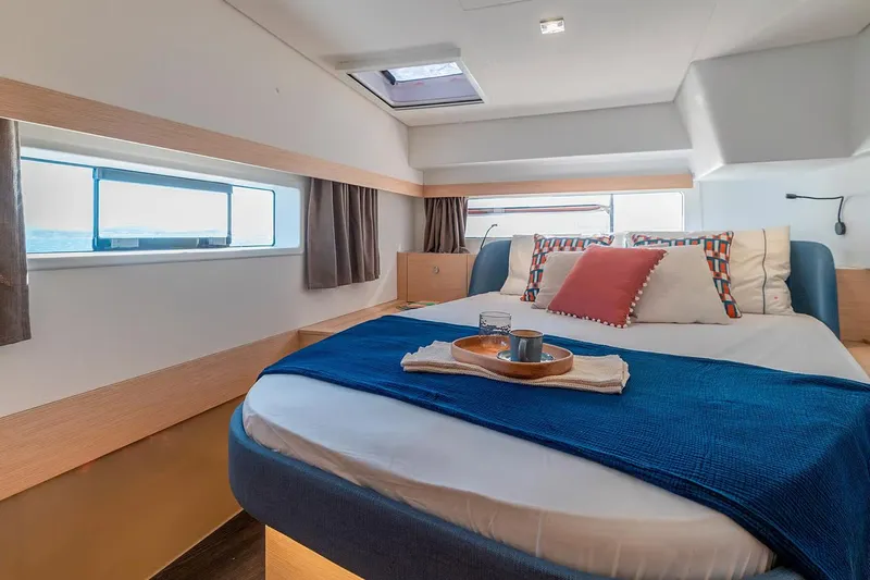  Yacht Photos Pics Manufacturer Provided Image: Luxurious bedroom interior of 2026 Fountaine Pajot FP44 Catamaran with modern decor and ocean view.