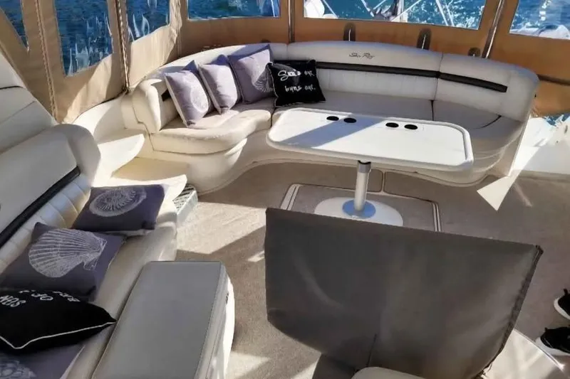  Yacht Photos Pics Luxurious interior of 2005 Sea Ray 500 Sundancer yacht with plush seating and table.