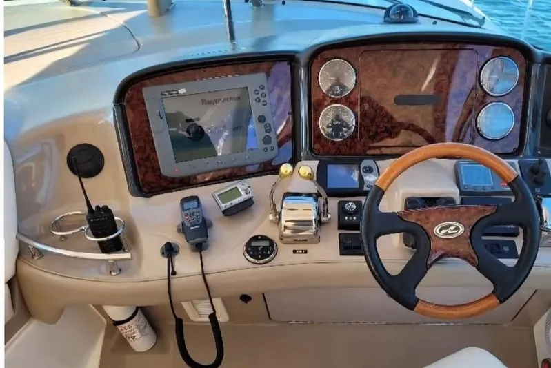  Yacht Photos Pics 2005 Sea Ray 500 Sundancer helm with navigation equipment and wood-accented steering wheel.