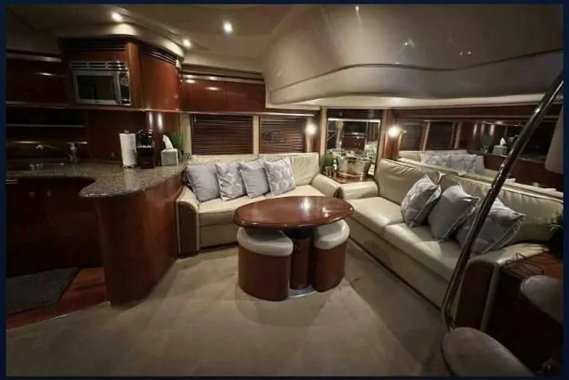  Yacht Photos Pics Luxurious interior of 2005 Sea Ray 500 Sundancer yacht with plush seating and elegant decor.
