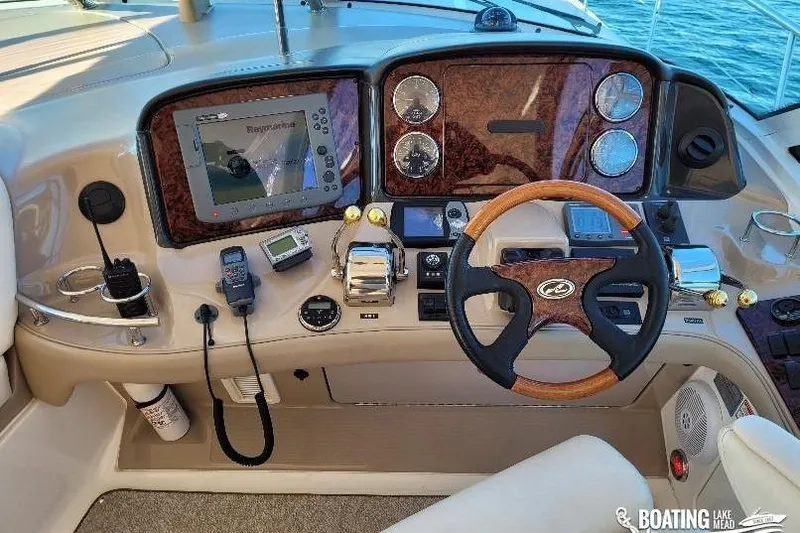  Yacht Photos Pics Cockpit of 2005 Sea Ray 500 Sundancer with steering wheel and navigation controls.
