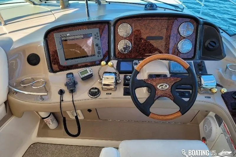  Yacht Photos Pics 2005 Sea Ray 500 Sundancer helm with navigation equipment and wooden steering wheel.