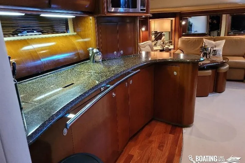  Yacht Photos Pics Luxurious interior of 2005 Sea Ray 500 Sundancer yacht with modern kitchen and seating area.
