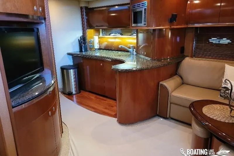  Yacht Photos Pics Luxurious interior of 2005 Sea Ray 500 Sundancer yacht with modern kitchen and seating area.