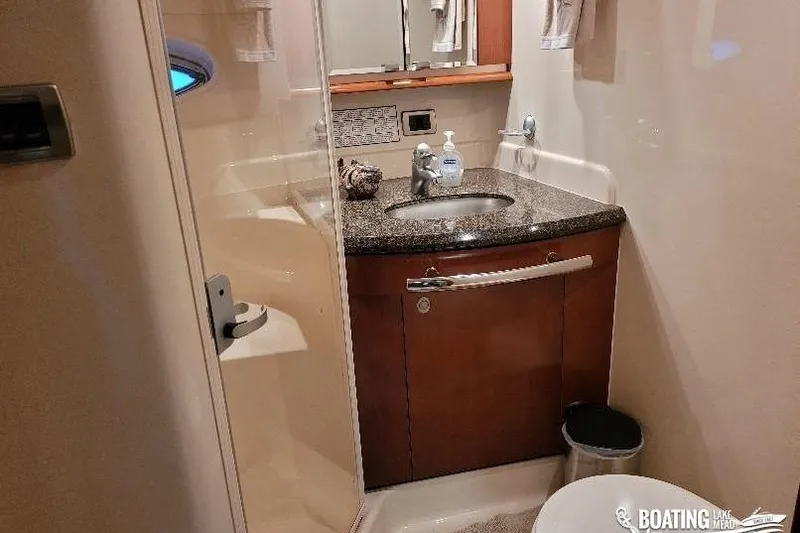  Yacht Photos Pics Luxurious bathroom in 2005 Sea Ray 500 Sundancer yacht with granite countertop and modern fixtures.