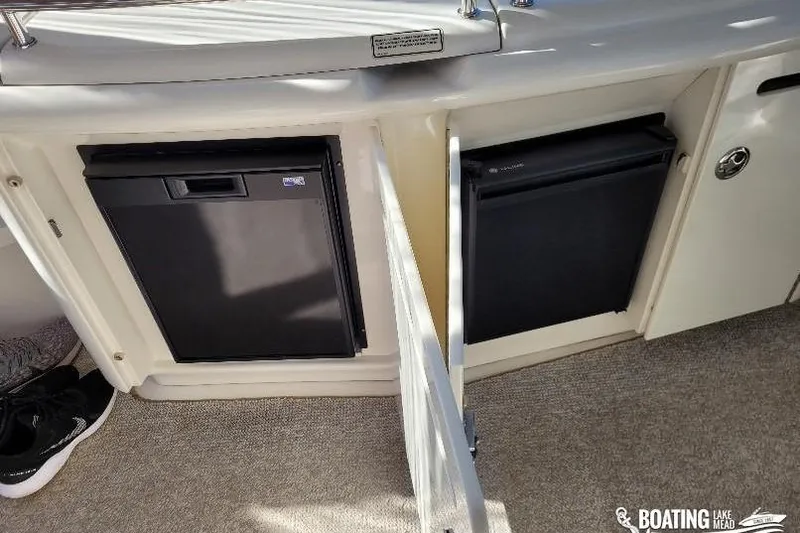  Yacht Photos Pics 2005 Sea Ray 500 Sundancer interior with open cabinets and mini-fridges.